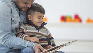 father reading to child