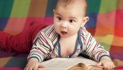 Baby reading on floor