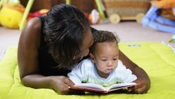 Mom reading to baby on the floor
