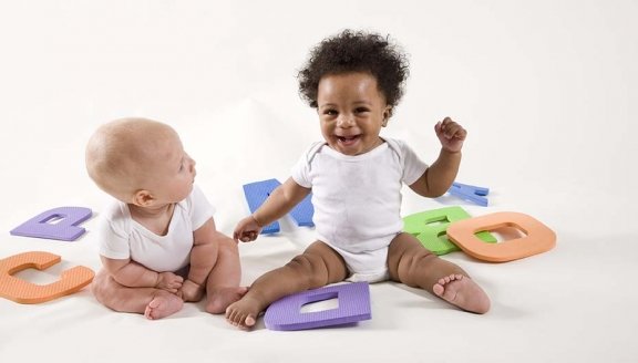 Babies learning ABC’s, playing with letters