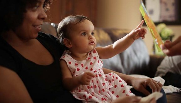 Mom reading to baby girl