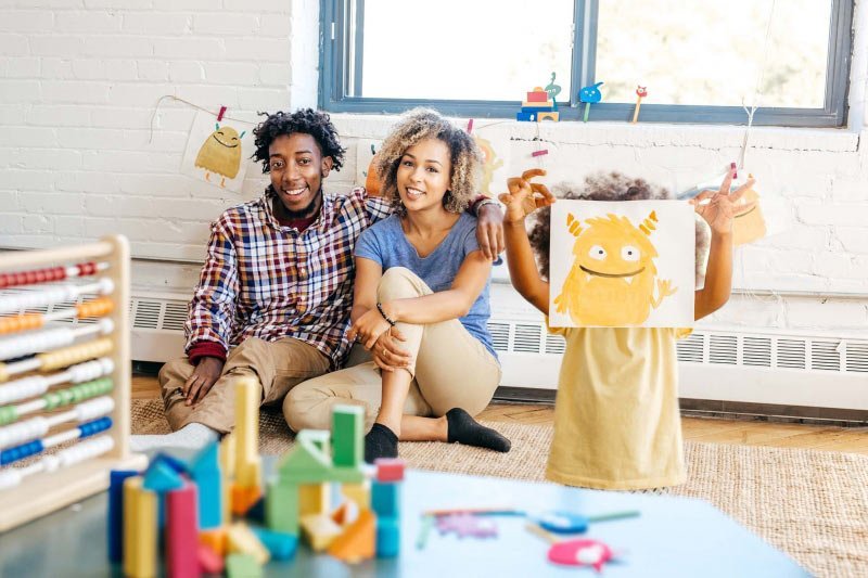 parents with child in playroom