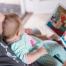 a man reading to a baby