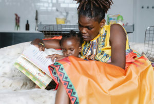 Mother reading to her infant child